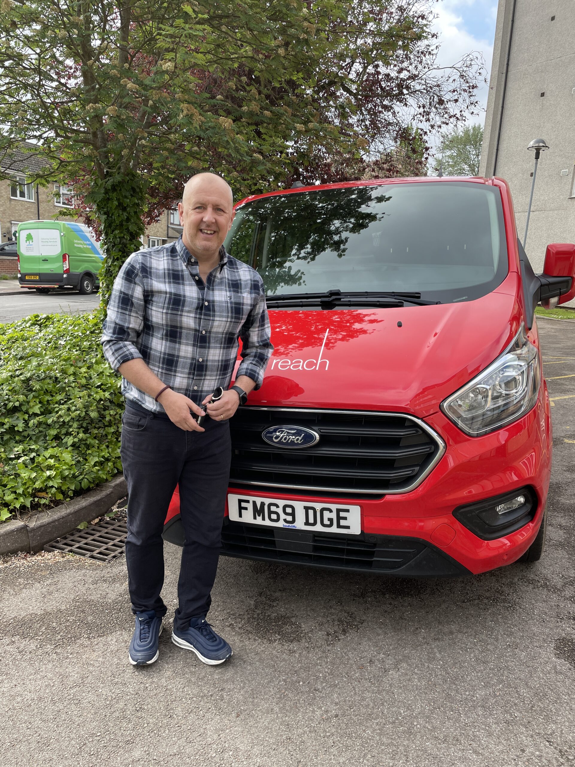 Photo of Wayne leaning against the Reach van