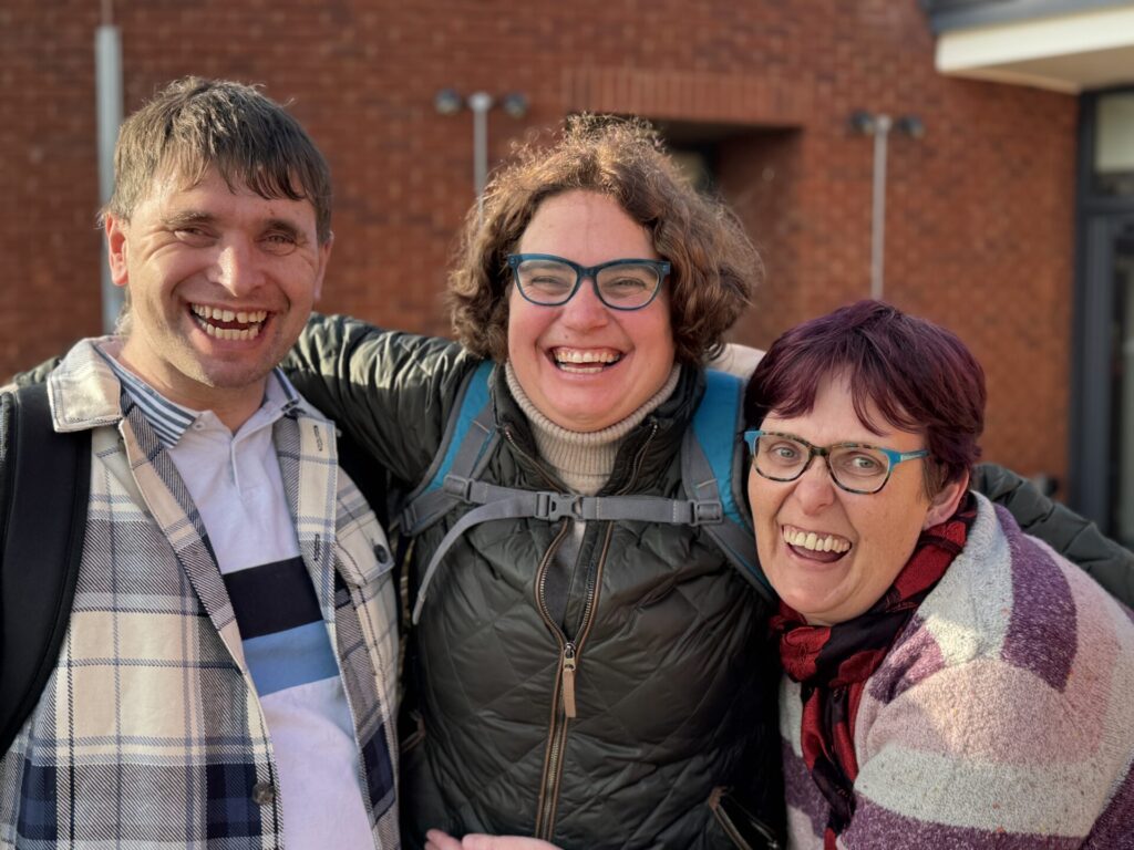 3 friends smiling at the camera
