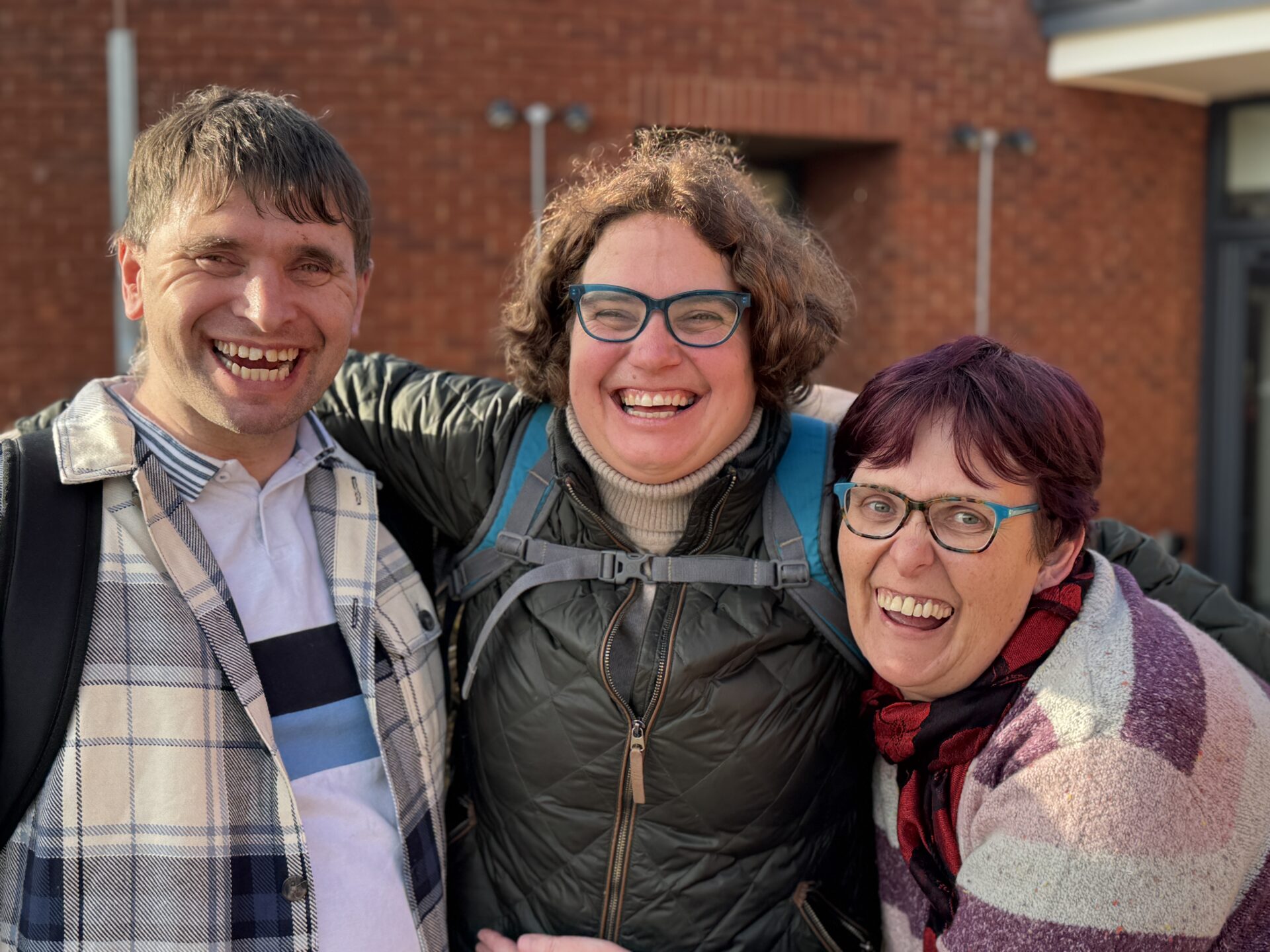 3 friends smiling at the camera